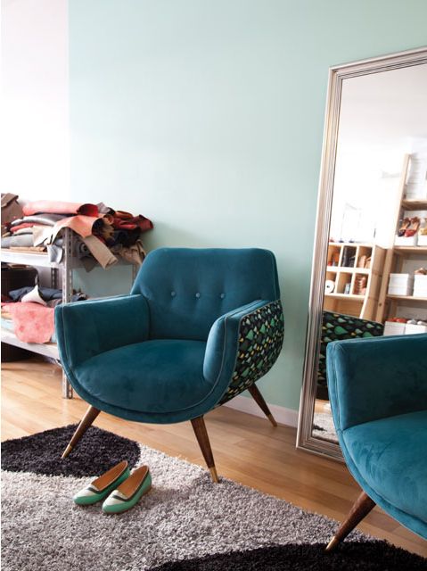 a cool rounded chair with teal upholstery and a printed curved base to make it stand out