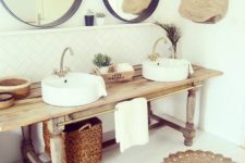 11 a wooden console, baskets, jute rugs and round mirrors to create a rustic boho feel in the bathroom