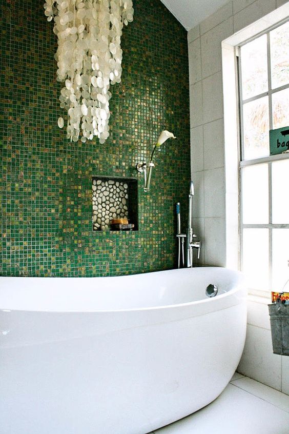 glossy green and gold glitter little tiles for an accent wall, mother of pearl chandelier create a glam space