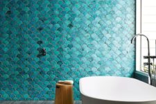 11 turquoise fish scale tiles covering a wall in the shower zone make a bold statement and catch an eye