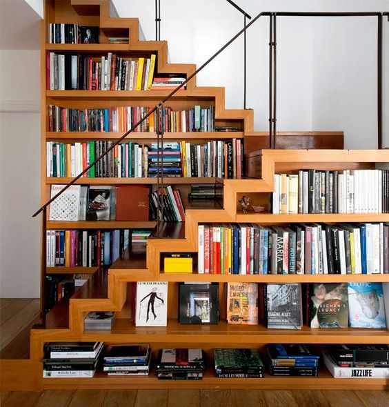 a creative staircase with bookshelves integrated right into it - a great space-saving idea
