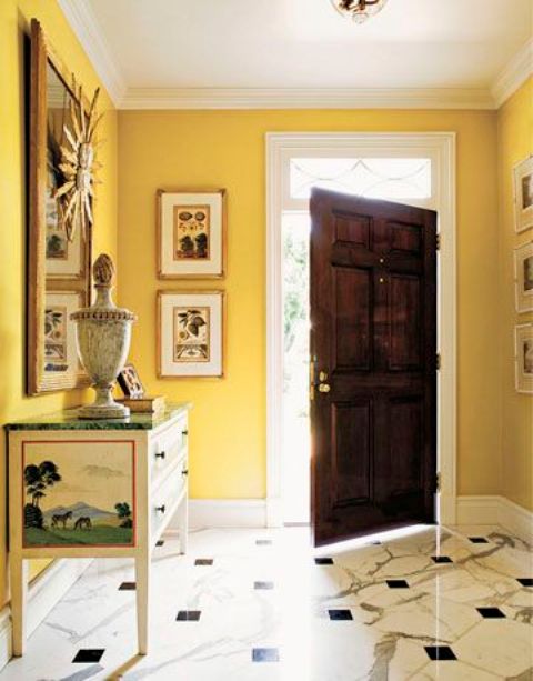 an yellow entryway seems to be filled with sunshine and looks bright, while yellow expands it