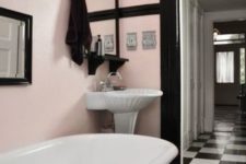 12 pink walls, black detailing and black and white checked floors create a chic vintage space