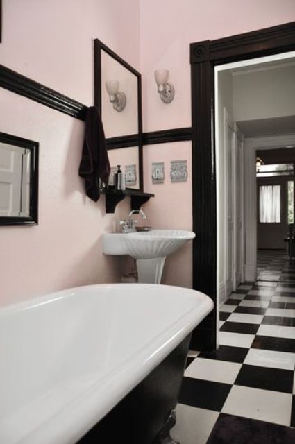 pink walls, black detailing and black and white checked floors create a chic vintage space