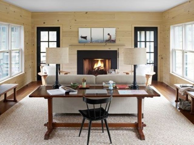 a cozy contemporary and natural living room with a vintage wooden desk behind the sofa that makes a statement