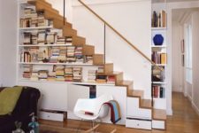 13 a modern staircase that features cabinets for storage and open bookshelves