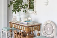 13 a whimsy and luxurious beach entryway with aqua touches, a basket for storage, white woven chairs, an encrysted console and a shell clad mirror