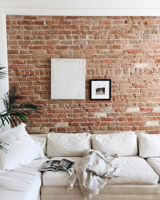 add coziness and texture to your living room making a brick accent wall or highlighting an existing one