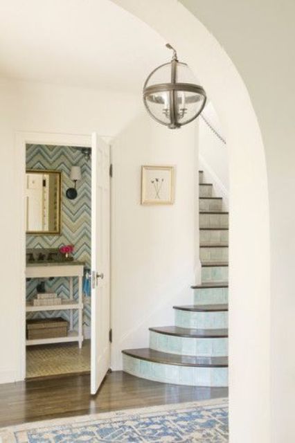 Eye catchy geometric wallpaper, an elegant mirror to make your powder room cooler