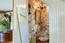 14 floral wallpaper is a trend for bathroom decor, and here it’s rocked right with a vintage bowl sink and wooden furniture