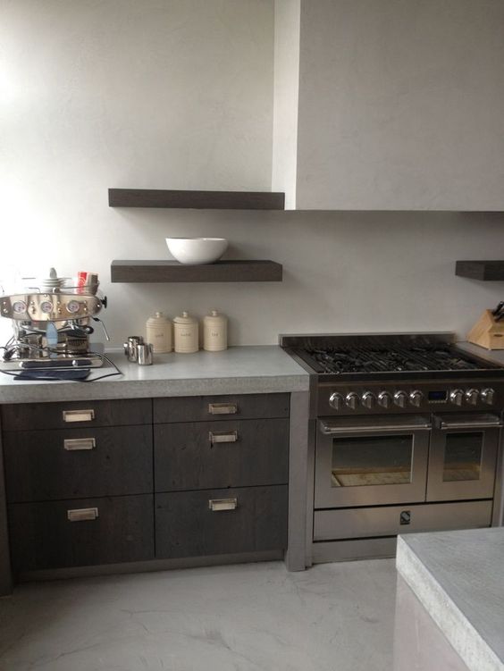 Light colored creamy concrete countertops and a backsplash for a contrast with dark stained cabinets