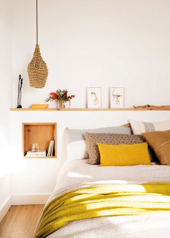 a neutral bedroom infused with light-colored wood, wicker and bright yellow touches