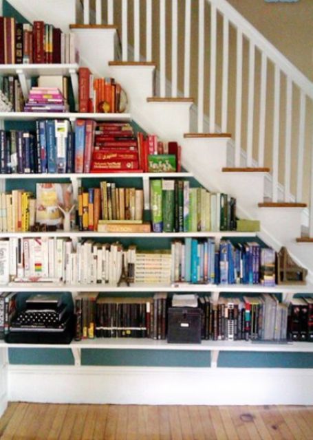 A staircase with built in bookshelves, which look rather airy due to being open ones