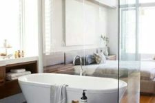 16 a free-standing bathtub spearated with a glass space divider for gentle separation