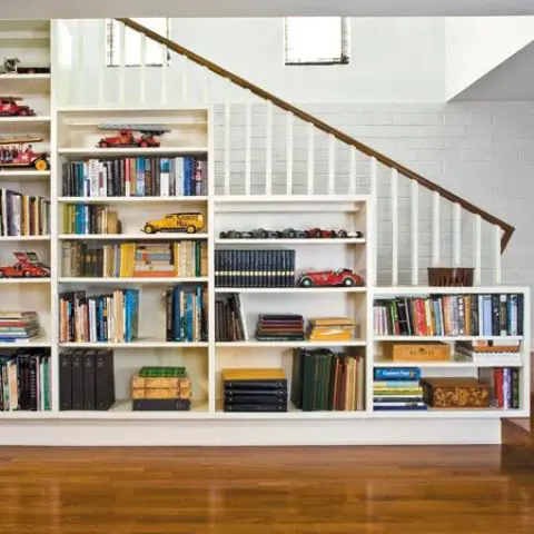 a traditional staircase with an open bookcase - just place a chair in front of it and voila