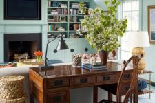 16 a vintage meets rustic living room with a gorgeous stained wooden desk and a matching chair behind the sofa