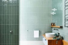 16 glossy pale green tiles and warm-colored wood create a very natural space with a calming effect