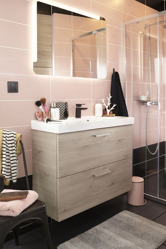 Large scale pink tiles and black ones on the floor for a catchy look and light colored wood for warmth