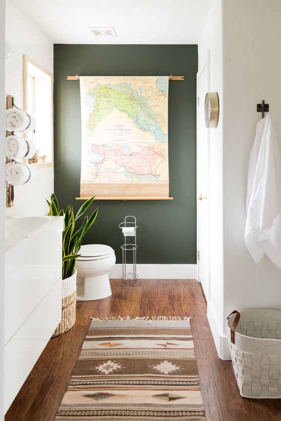 a black statement wall, baskets, a potted succulent and a map as an artwork