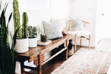 17 a boho rug, a vintage wooden bench, a chair, pillows and cacti and succulents in pots
