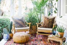 17 a chic boho porch with potted greenery, succulents, rattan furniture, a boho rug and a lather ottoman