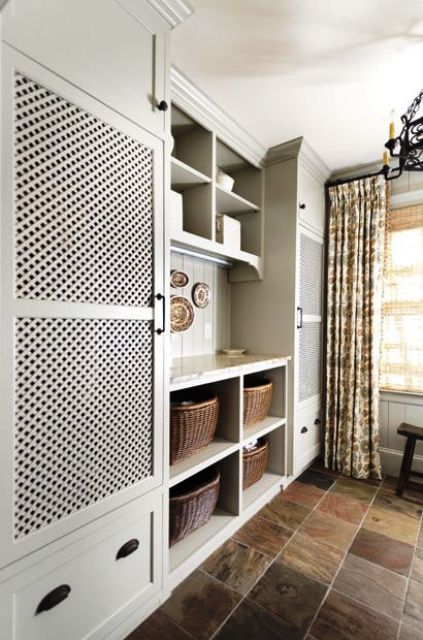 a traditional laundry with a washer and dryer behind lattice doors makes using them easy and you avoid the clutter