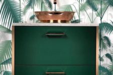 18 a chic dark green floatign vanity with copper touches and a palm leaf wall for en elegant look