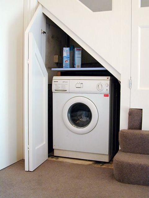 even a small staircase can accommodate a tiny laundry like this one