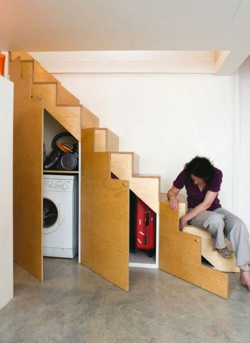 a little laundry and a storage space incorporated into the under stairs space