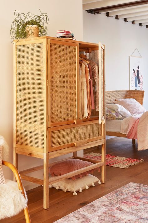 A vintage inspired wood lettice cabinet is ideal as a wardrobe for a summer home