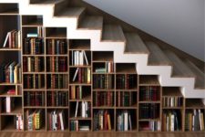 19 a whole under stairs bookcase features many books and can hold some other objects, too
