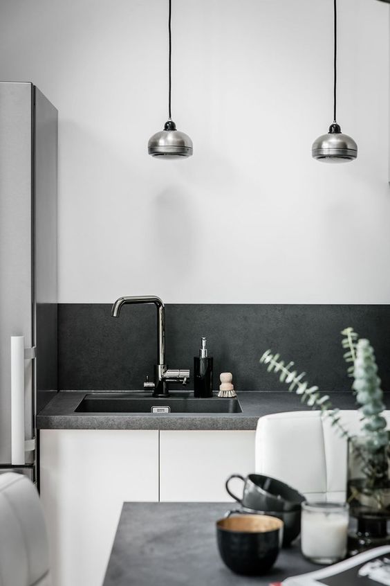 a Scandinavian space with a concrete countertop and backsplash that look very stylish and neat
