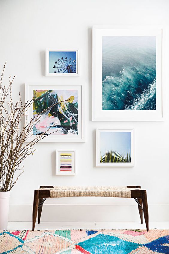 A beach entryway with a woven bench and beach inspired artworks to welcome visitors
