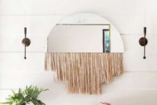 20 a boho space with a woven bench, a woven basket, a mirror with fringe and a potted plant