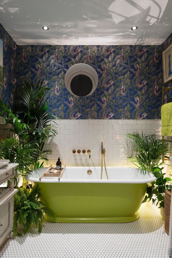 a creative bathroom design with a grass green free-standing bathtub and living greenery in pots