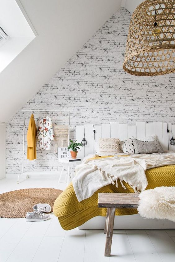 a neutral space spruced up with a wicker lampshades, a just rug, yellow touches here and there