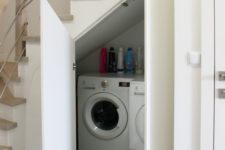 20 a small laundry with a washing machine and a dryer and with doors