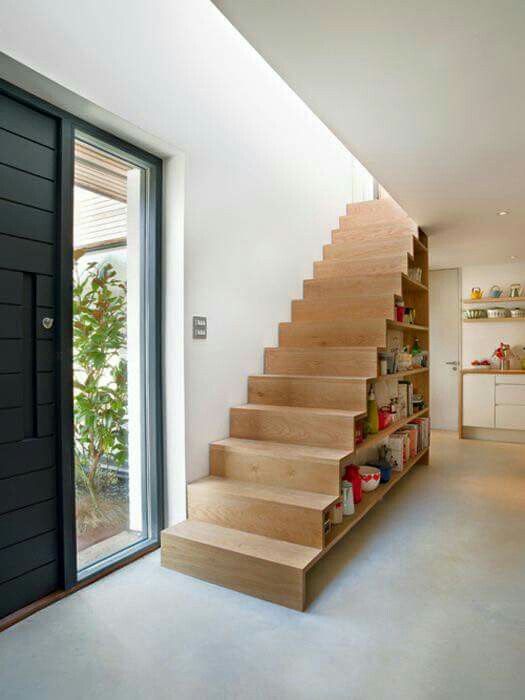 a wooden staircase with books inside is a creative and practical way to store them all