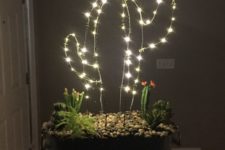 21 a gorgeous arrangement with cacti, succulents and a LED cactus with a flower on top