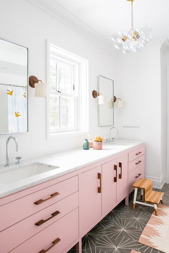 a long and large light pink console with wooden handles and a marble top for a chic glam look