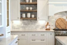 21 a traditional white kitchen with grey marble subway tiles on the backsplash and walls plus wooden touches