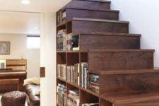 21 a wooden staircase with compartments for storage filled with books