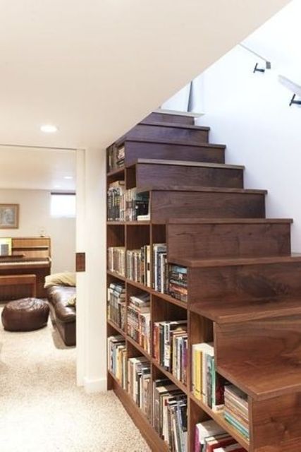 a wooden staircase with compartments for storage filled with books