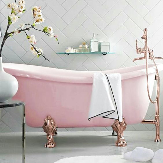 a refined pink bathtub with copper clawfoot legs for a gorgeous and sophisticated space
