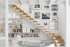 22 an airy whitewashed Scandinavian space with floating bookshelves under the stairs