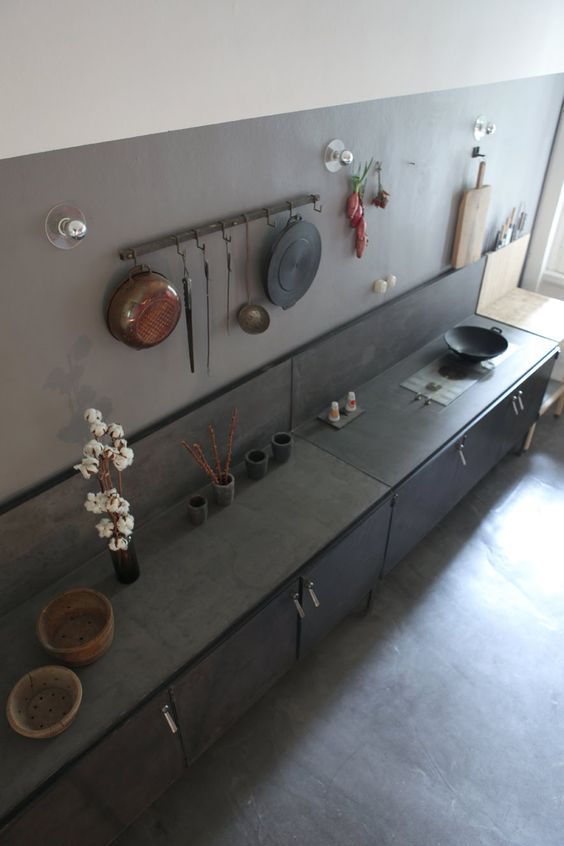 black metal cabinets and a grey reinforced concrete backsplash and countertop for an industrial look