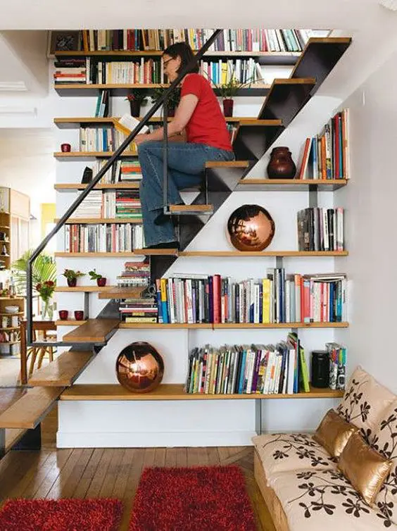 Bookshelves built in into the staircase itself   use the steps for sitting there