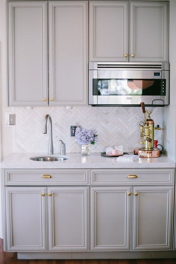 elegant marble tiles clad in a chevron pattern is a chic and elegant idea suitable for a traditional kitchen