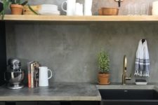 black metal cabinets, an open shelf and a concrete backsplash and countertops for an industrial look