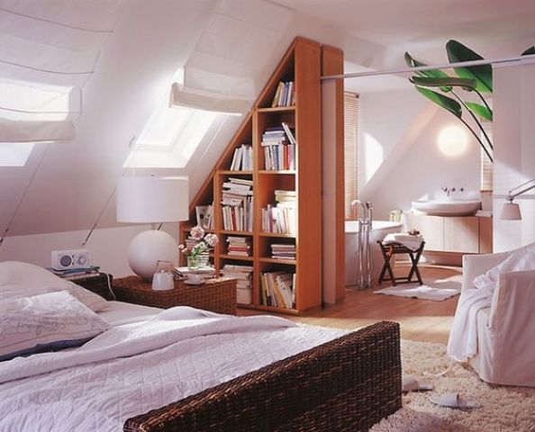 divide the spaces with a large triangle-shaped bookshelf that perfectly fits the attic roof